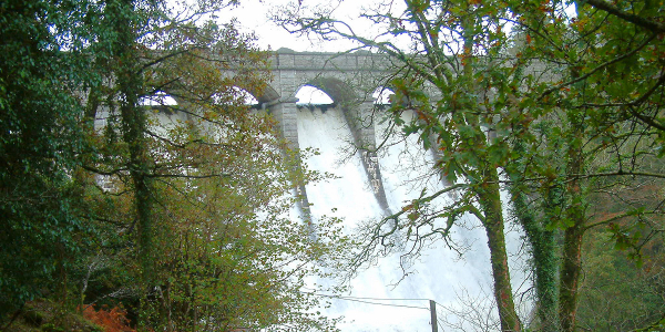 Water cascades over Burrator Dam after days of very heavy rain